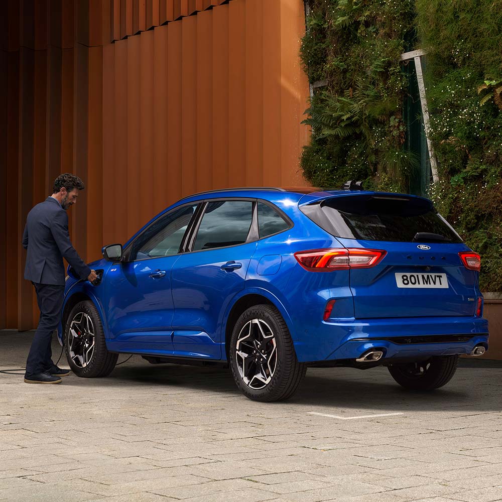 Blue All-New Ford Kuga PHEV charging at home