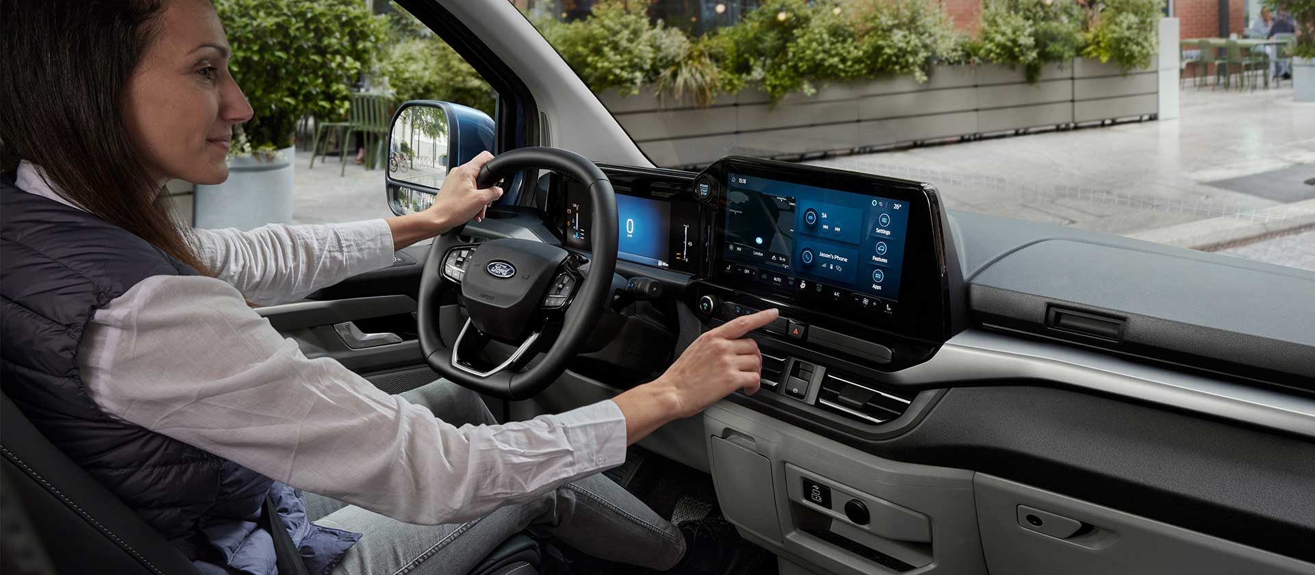 Person inside the All-New Tourneo Custom using the dash screen