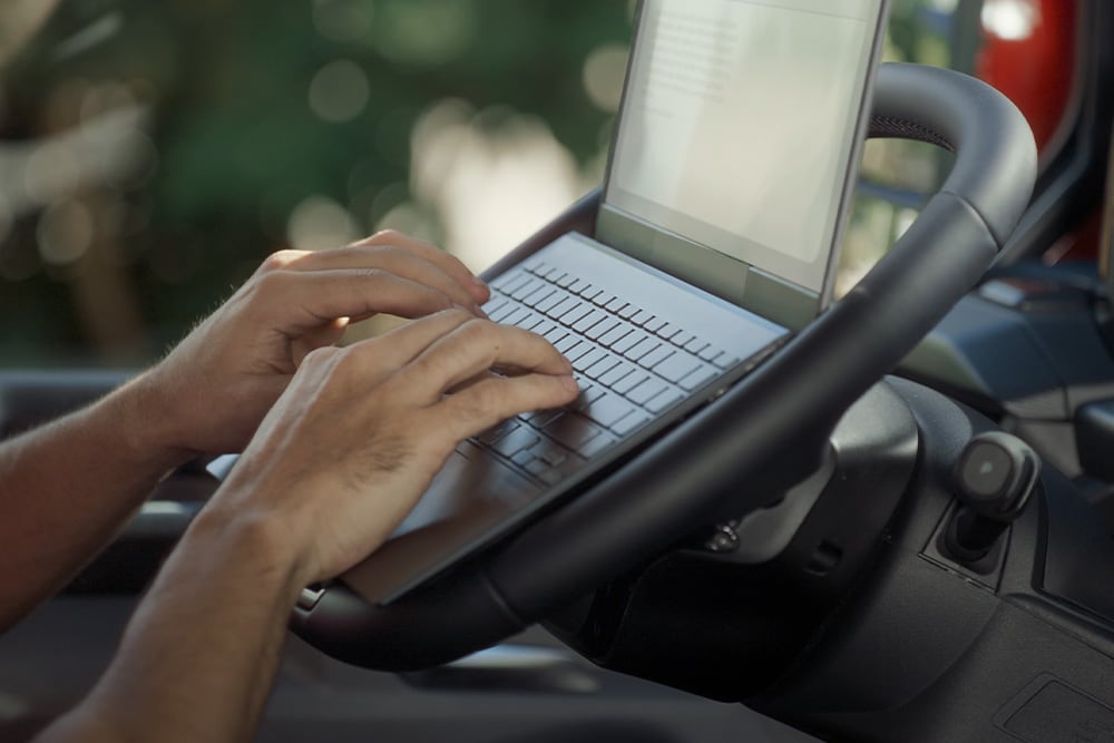 Person using laptop inside the All-New Tourneo Custom