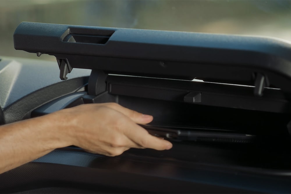 Person putting things in the storage compartment in the All-New Tourneo Custom
