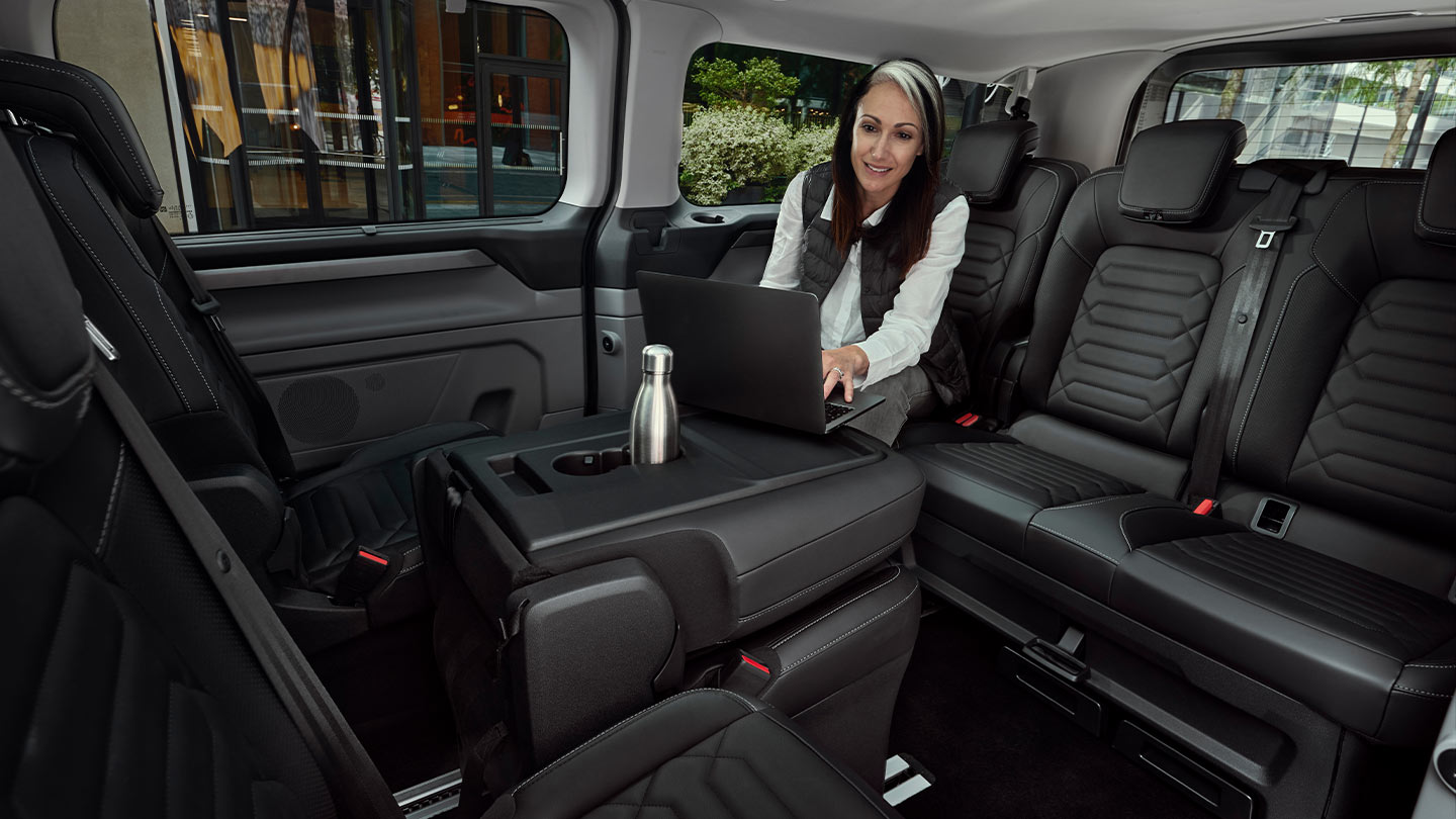 Person using a laptop inside the All-New Tourneo Custom