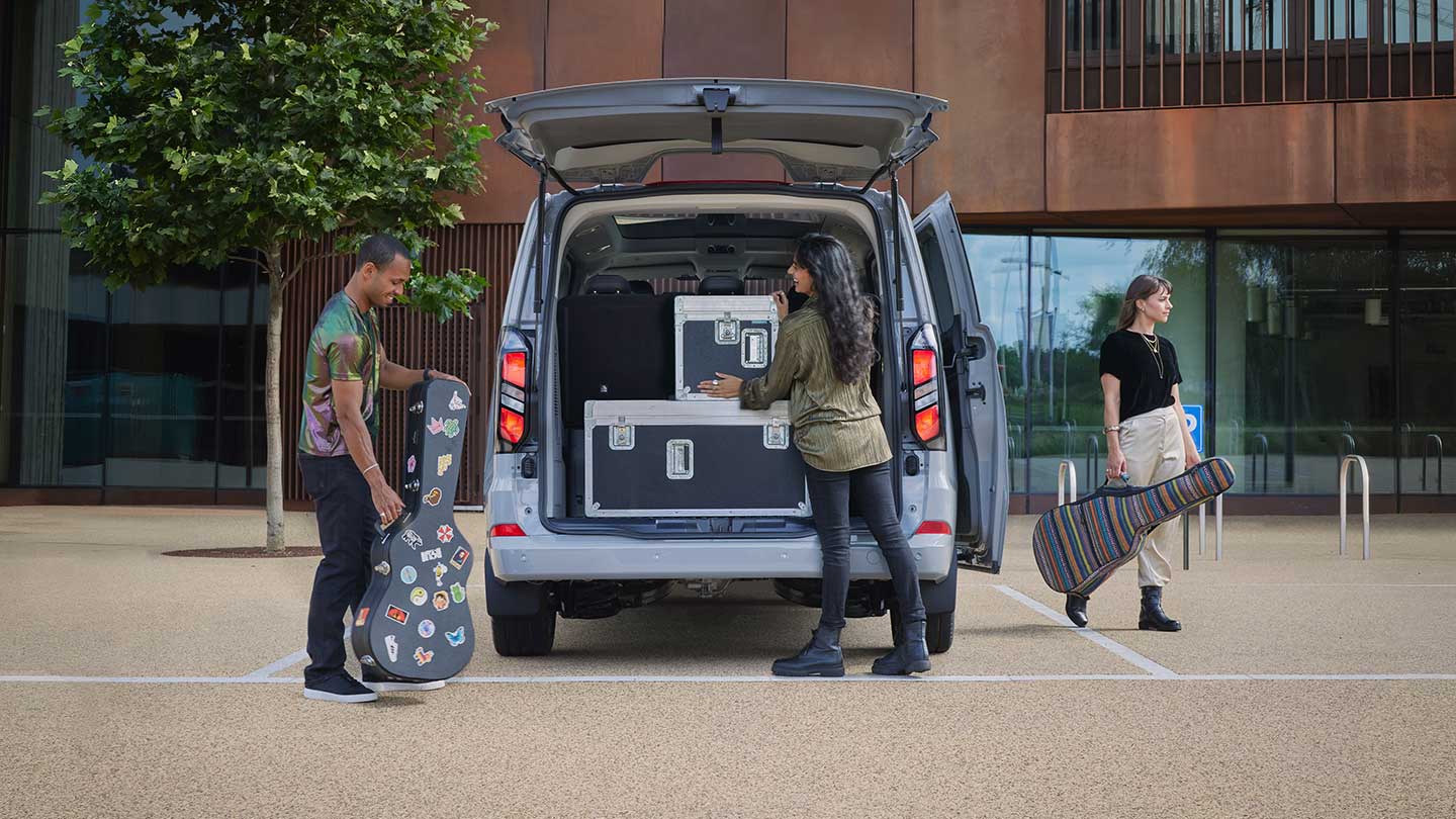People putting luggage in the back of the All-New Tourneo Custom