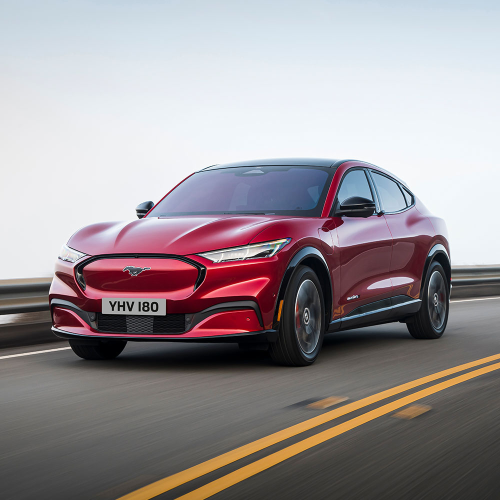 1000x1000 image of a grey Puma Gen-E parked on a main road.